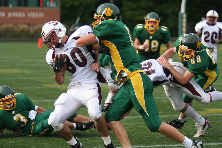 Collegiate School�s junior, Jake McGee (center) puts a big hit on St. Anne�s Belfield�s Michael Battle (#80) during Friday afternoon�s game at Collegiate.  � Mike Lynaugh