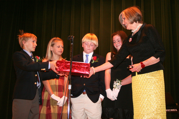 Richmond’s Christmas Mother, Charlotte Minor accepts donations by the participants of the Town & Country Cotillion Holly Ball. Ms. Minor is joined on stage by sixth graders (L-R) Graham Augustine Ferguson, Frances Carter Leake, Herbert Epes Fitzgerald IV and Leeds Lawson McVey, the granddaughter of Mrs. Nan McVey, former Christmas Mother. © Mike Lynaugh
