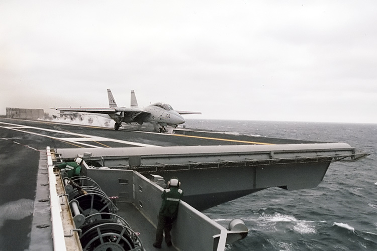 An F-14 Tomcat from VF-32 "The Swordsmen" roars off the flight deck of the U.S.S. Enterprise, CVN-65, into a rainy sky out in the Atlantic Ocean. �  � Mike Lynaugh