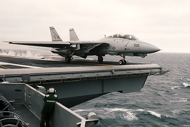An F-14 Tomcat from VF-32 "The Swordsmen" roars off the flight deck of the U.S.S. Enterprise, CVN-65, into a rainy sky out in the Atlantic Ocean. �  � Mike Lynaugh