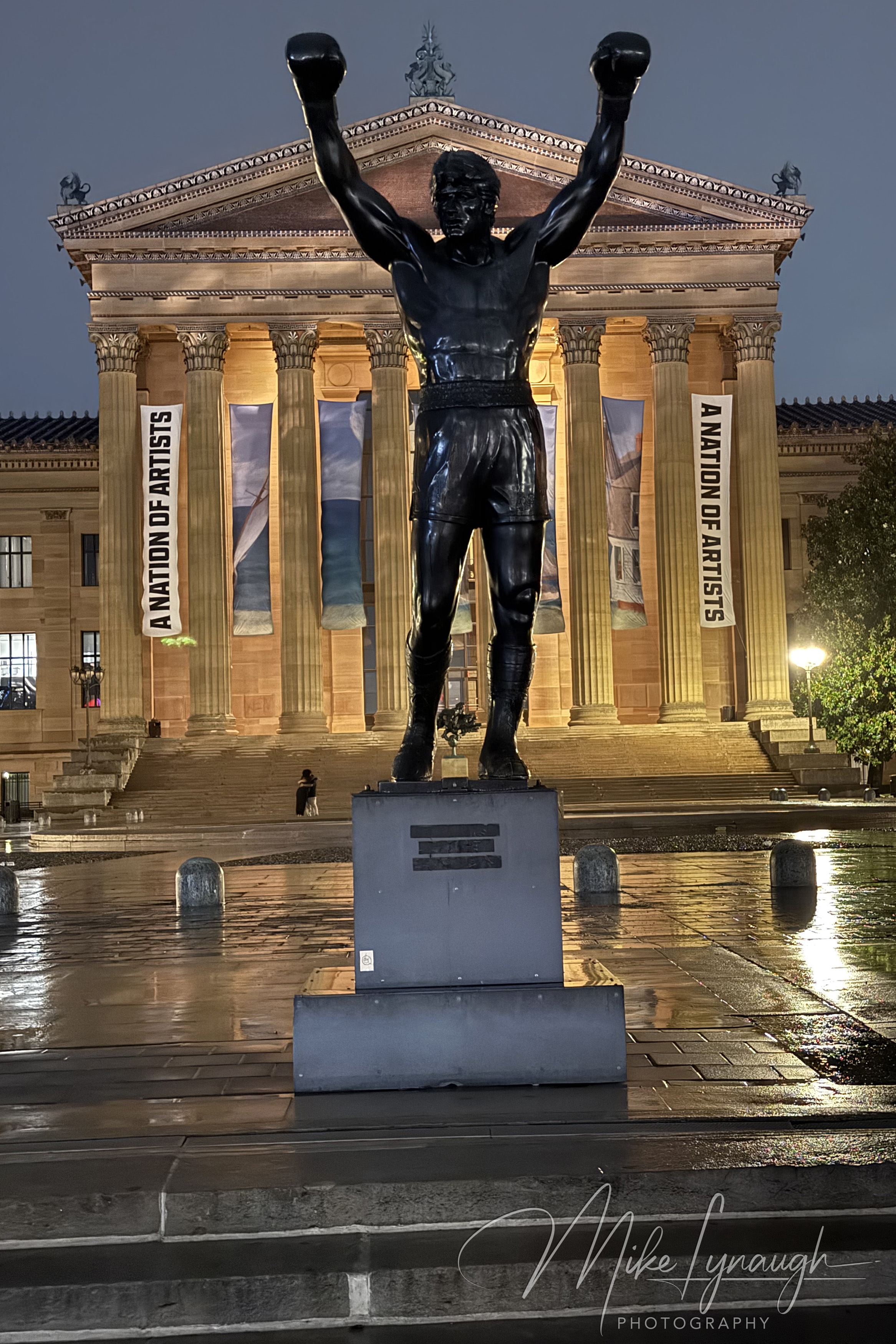 The Rocky statue photographed during a rainy evening at the top of the Rocky Steps at the Philadelphia Museum of Art.