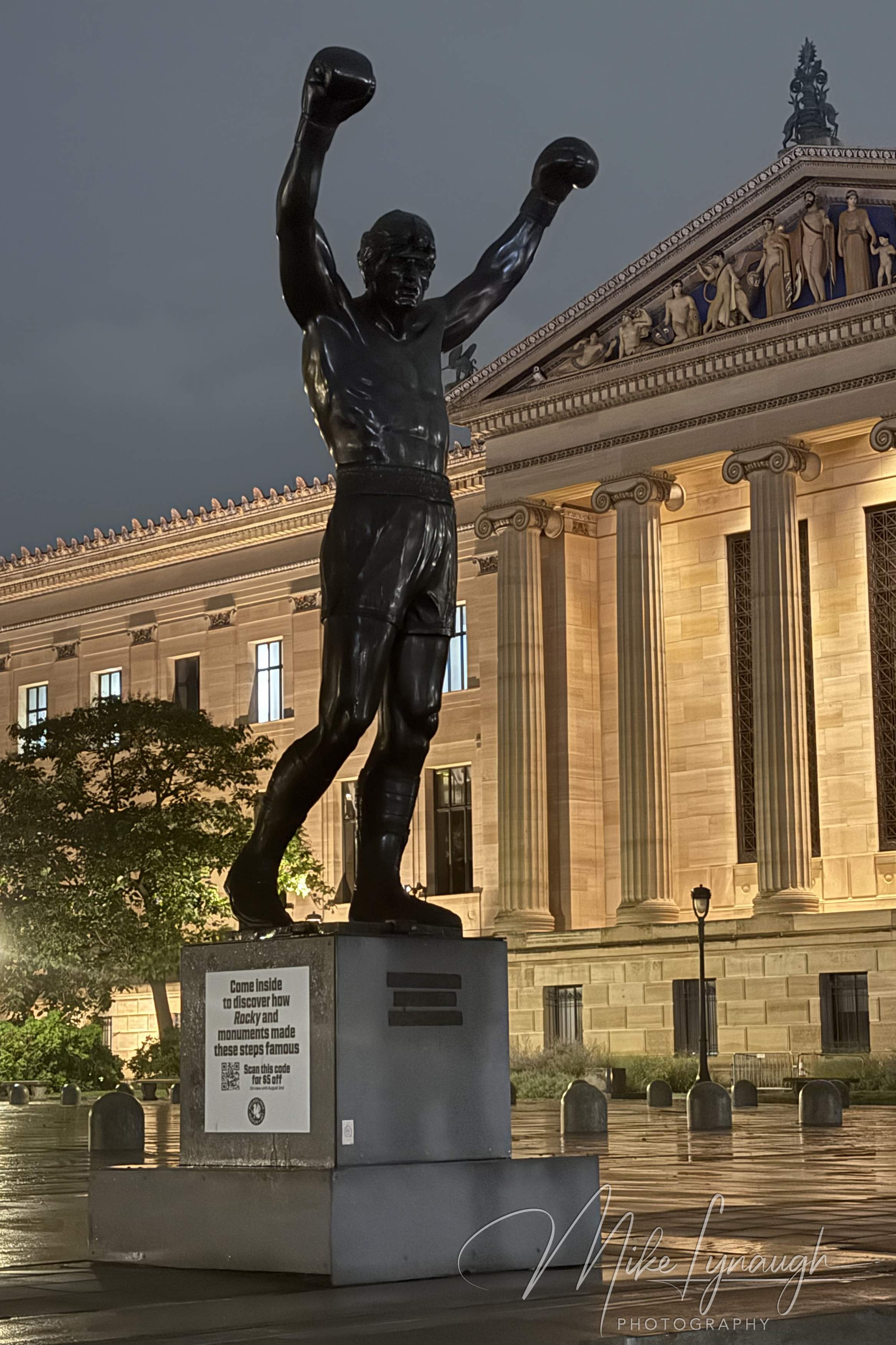 The Rocky statue photographed during a rainy evening at the top of the Rocky Steps at the Philadelphia Museum of Art.