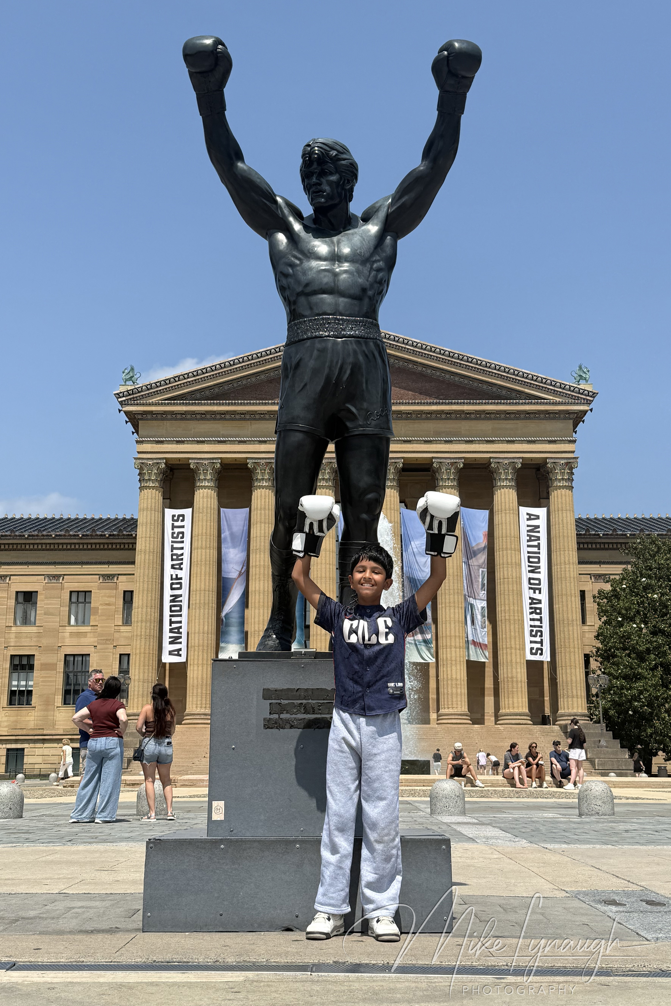 Rocky Statue — Posing with Rocky. Mikey Lynaugh strikes the iconic Rocky pose at the Rocky Statue at the top of the Rocky steps at the Philadelphia Museum of Art.