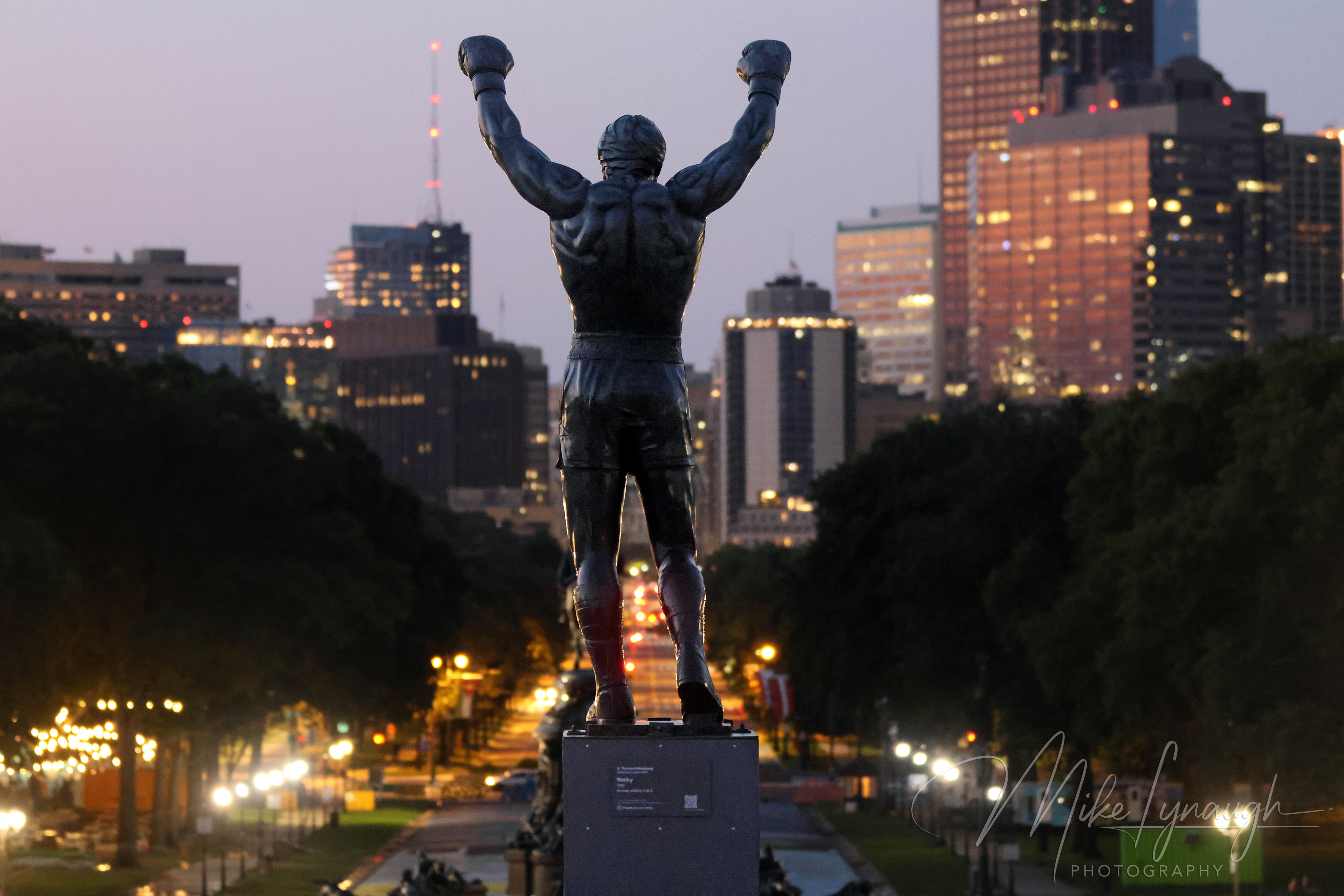 Rocky Statue — Sunrise at the Philadelphia Museum of Art and Skyline. Sylvester Stallone's personal Rocky Statue overlooks the Philadelphia skyline as the morning light begins to illuminate the city.