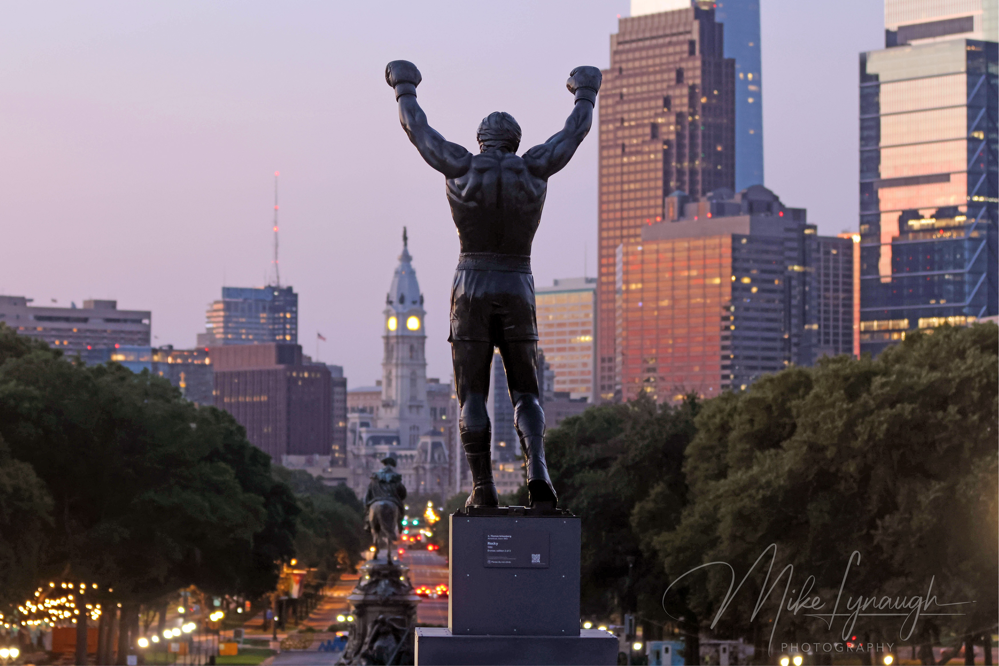 Rocky Statue — Sunrise at the Philadelphia Museum of Art and Skyline. Sylvester Stallone's personal Rocky Statue overlooks the Philadelphia skyline as the morning light begins to illuminate the city.