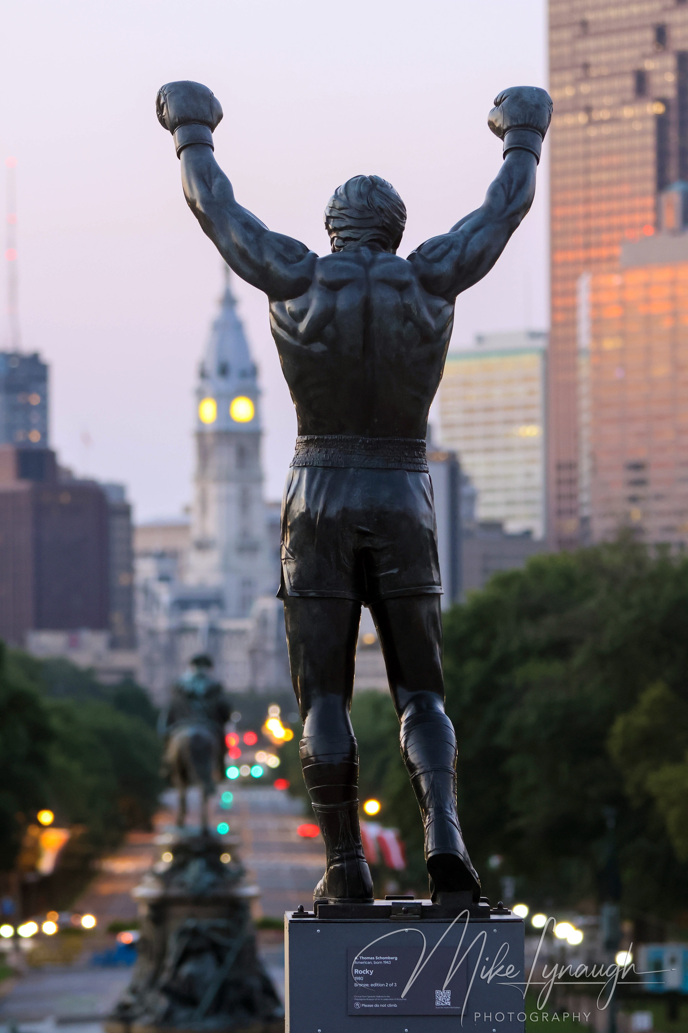 Sylvester Stallone's personal Rocky Statue overlooks the Philadelphia skyline as the morning light begins to illuminate the city.