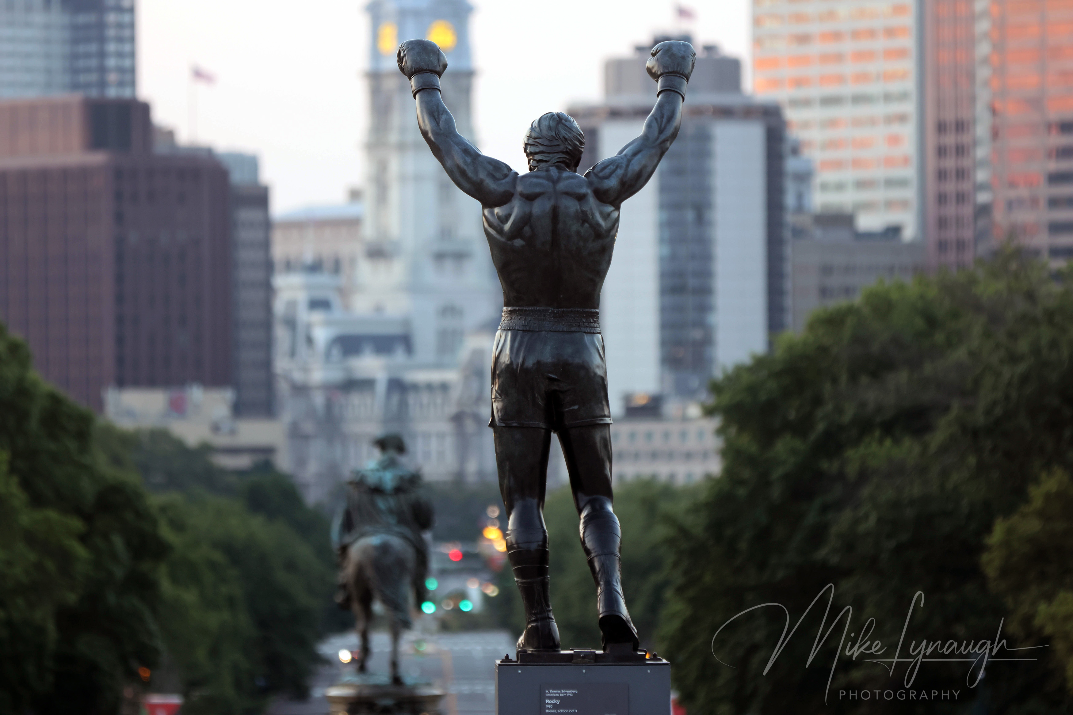 Sylvester Stallone's personal Rocky Statue overlooks the Philadelphia skyline as the morning light begins to illuminate the city.