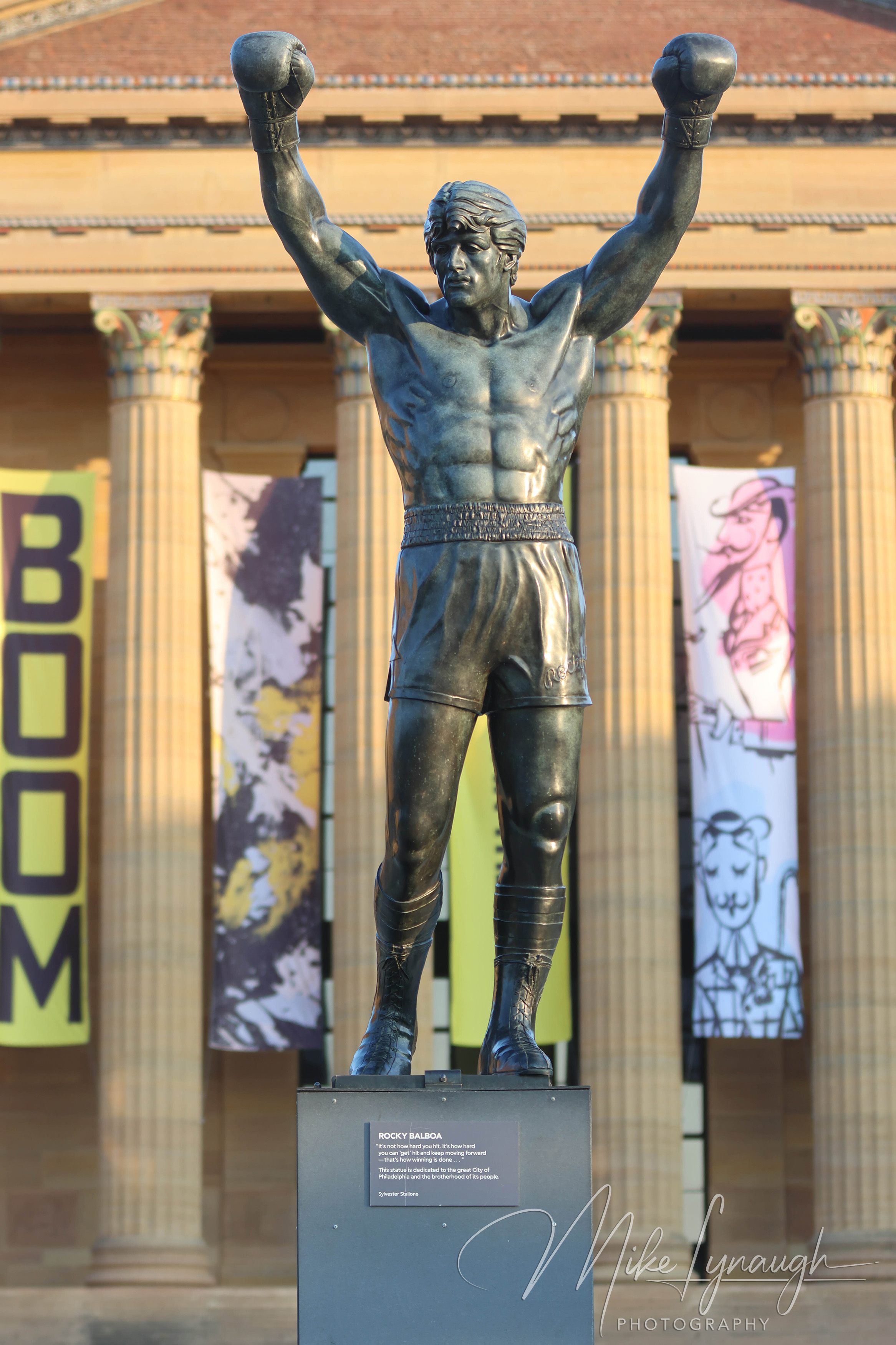 Rocky Statue — Sunrise illuminates the Rocky Statue at the top of the Rocky Steps. Sylvester Stallone's personal Rocky Statue framed with the pillars of the main entrance to the Philadelphia Museum of Art.
