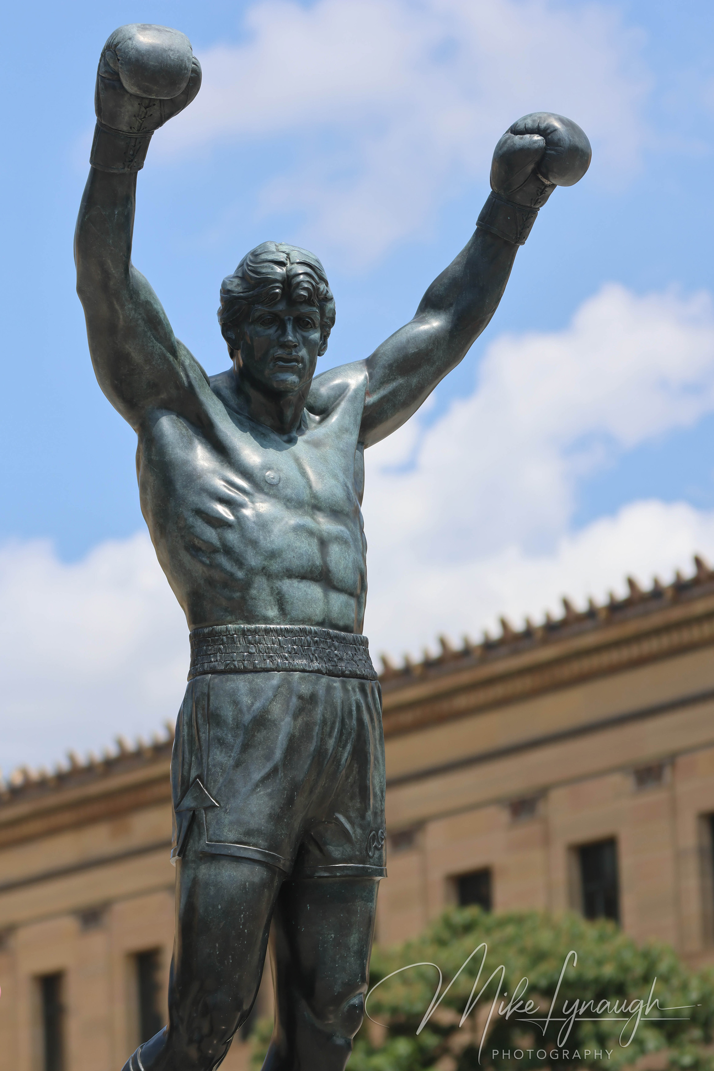 Rocky Statue — At the top of the Rocky Steps. A vertical photo of Sylvester Stallone's personal Rocky Statue during a beautifl day at the Philadelphia Museum of Art.
