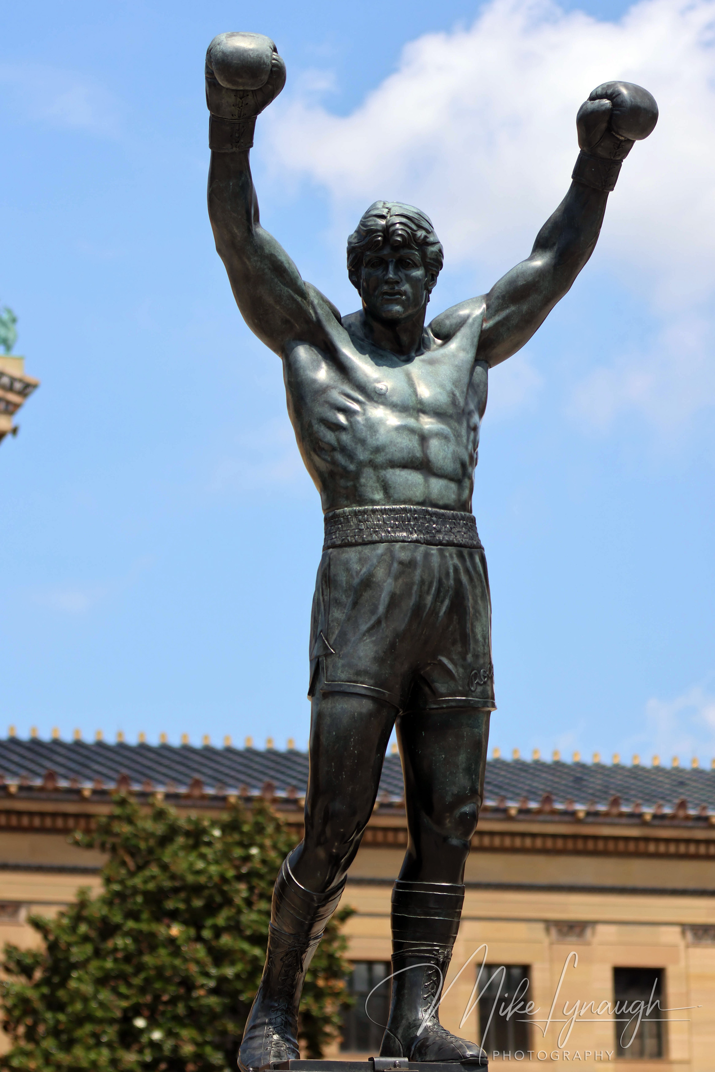 Rocky Statue — At the top of the Rocky Steps. A vertical photo of Sylvester Stallone's personal Rocky Statue during a beautifl day at the Philadelphia Museum of Art.