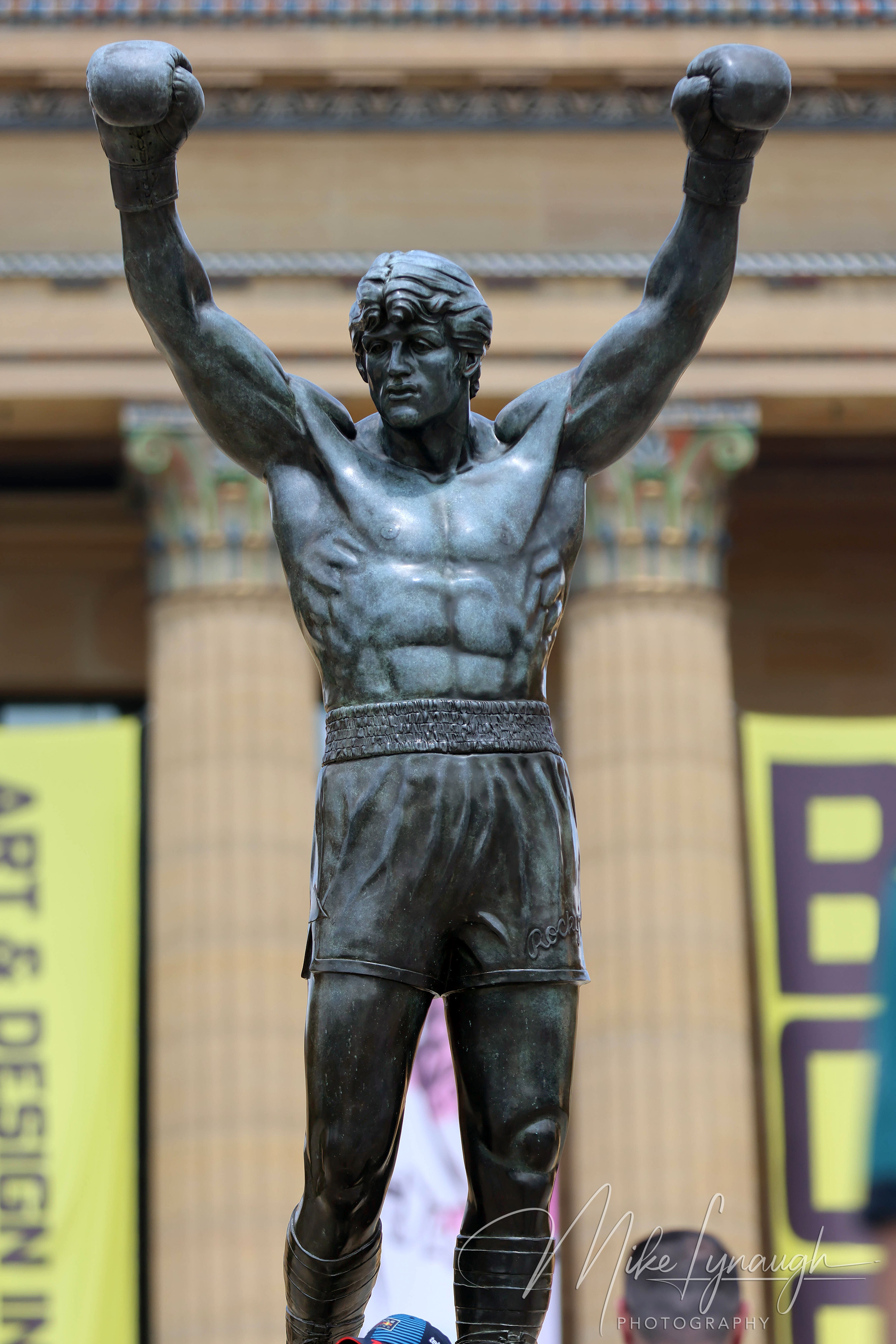 Rocky Statue — At the top of the Rocky Steps. Sylvester Stallone's personal Rocky Statue framed with the pillars of the main entrance to the Philadelphia Museum of Art.