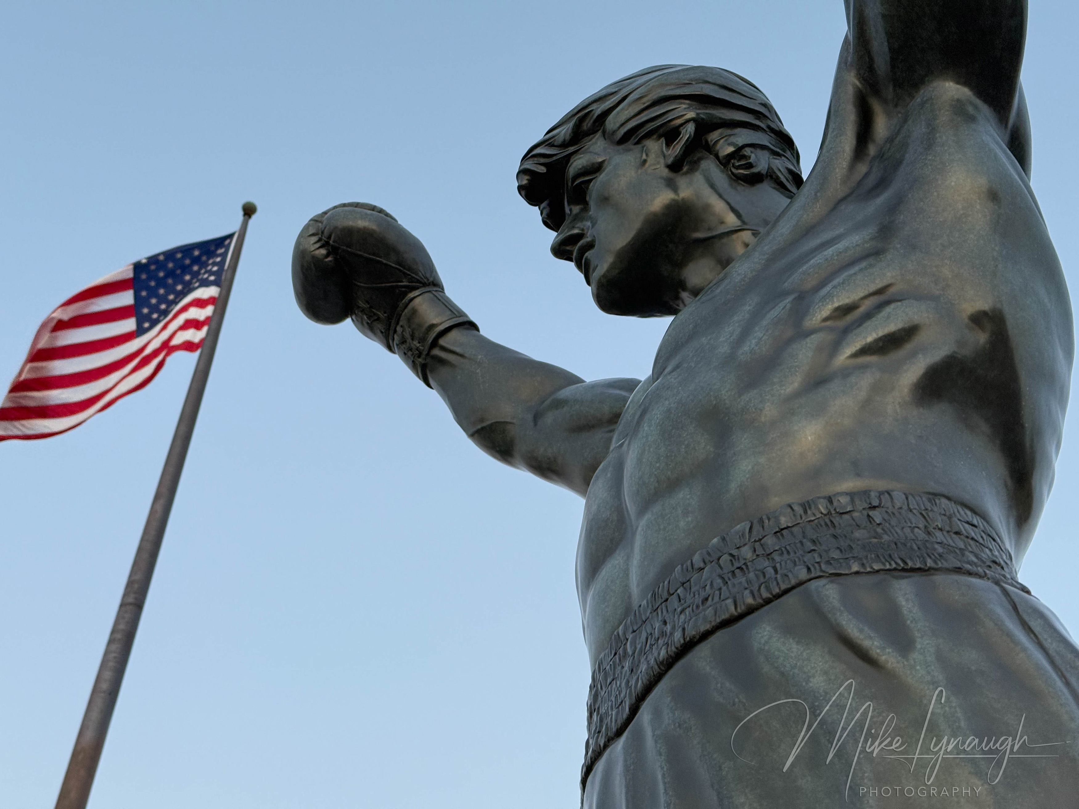 Looking up at the Rocky Statue and American Flag at the top of the Rocky Steps at the Philadelphia Museum of Art.