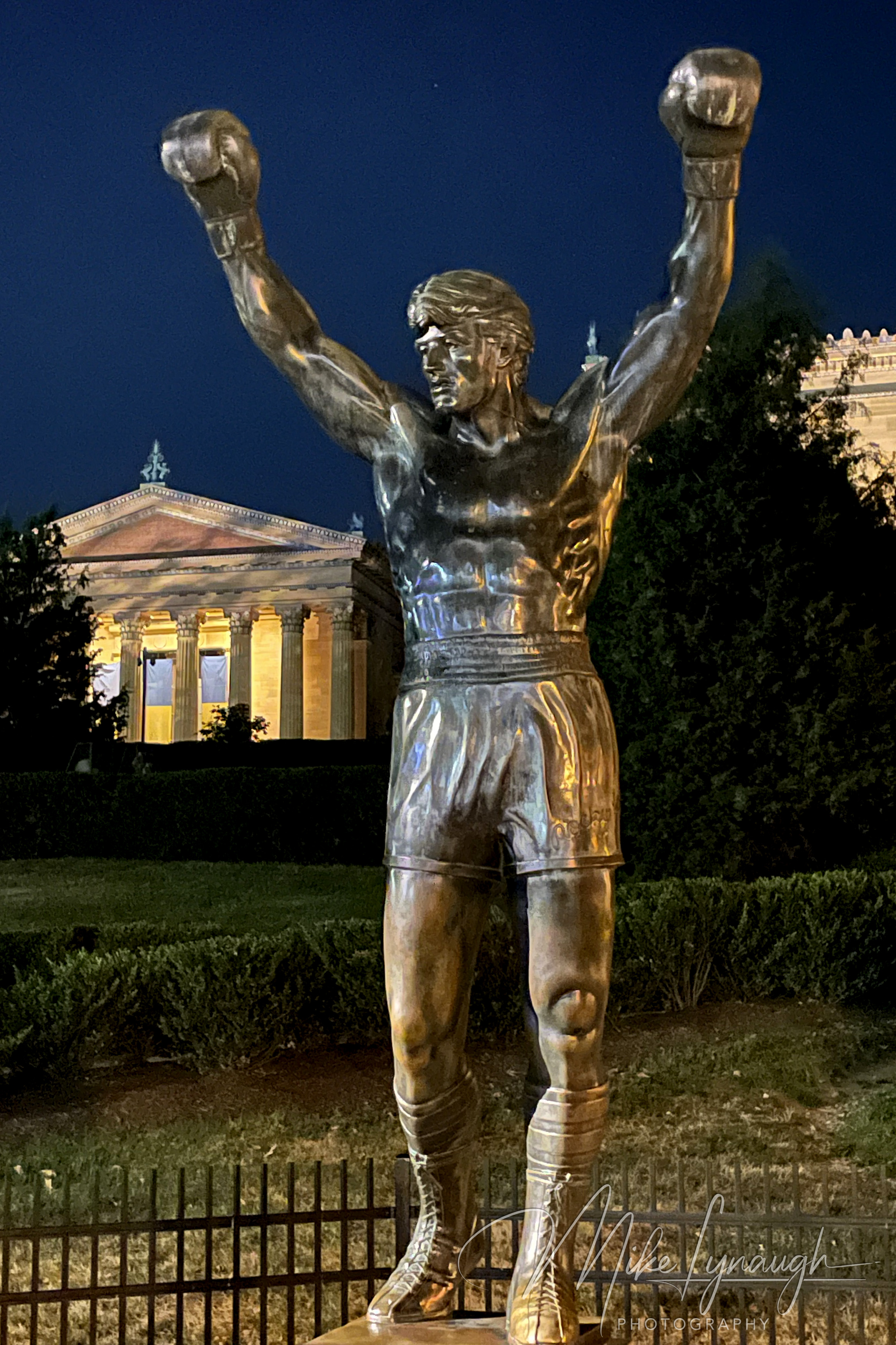 The original Rocky Statue that was featured in the movie Rocky III stands proudly at night at the base of the iconic Rocky Steps.