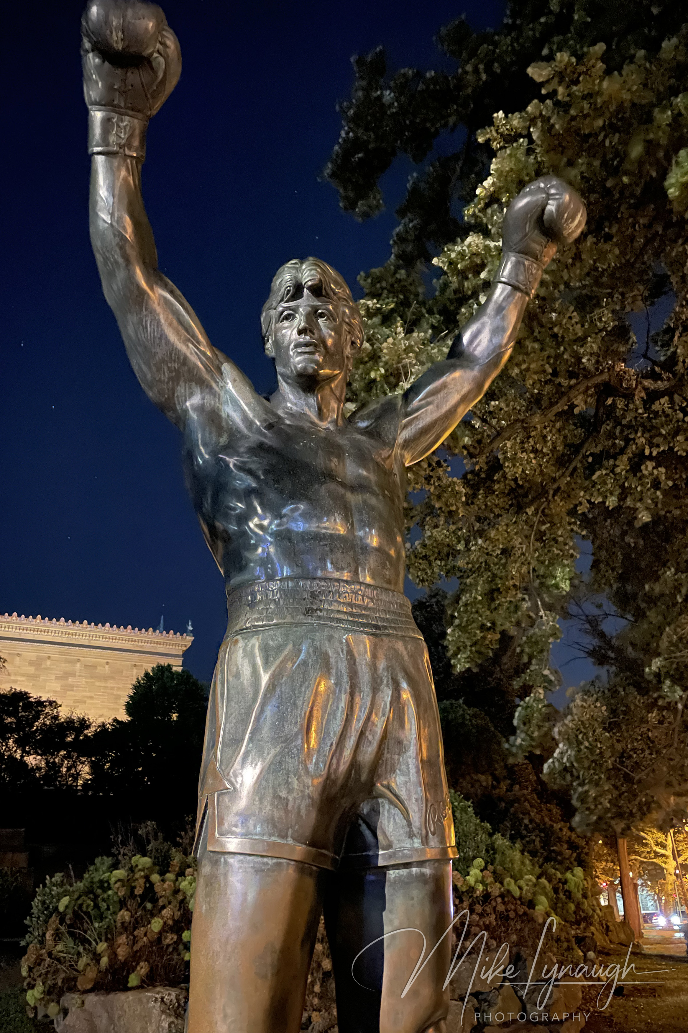 The original Rocky Statue that was featured in the movie Rocky III stands proudly at night at the base of the iconic Rocky Steps.