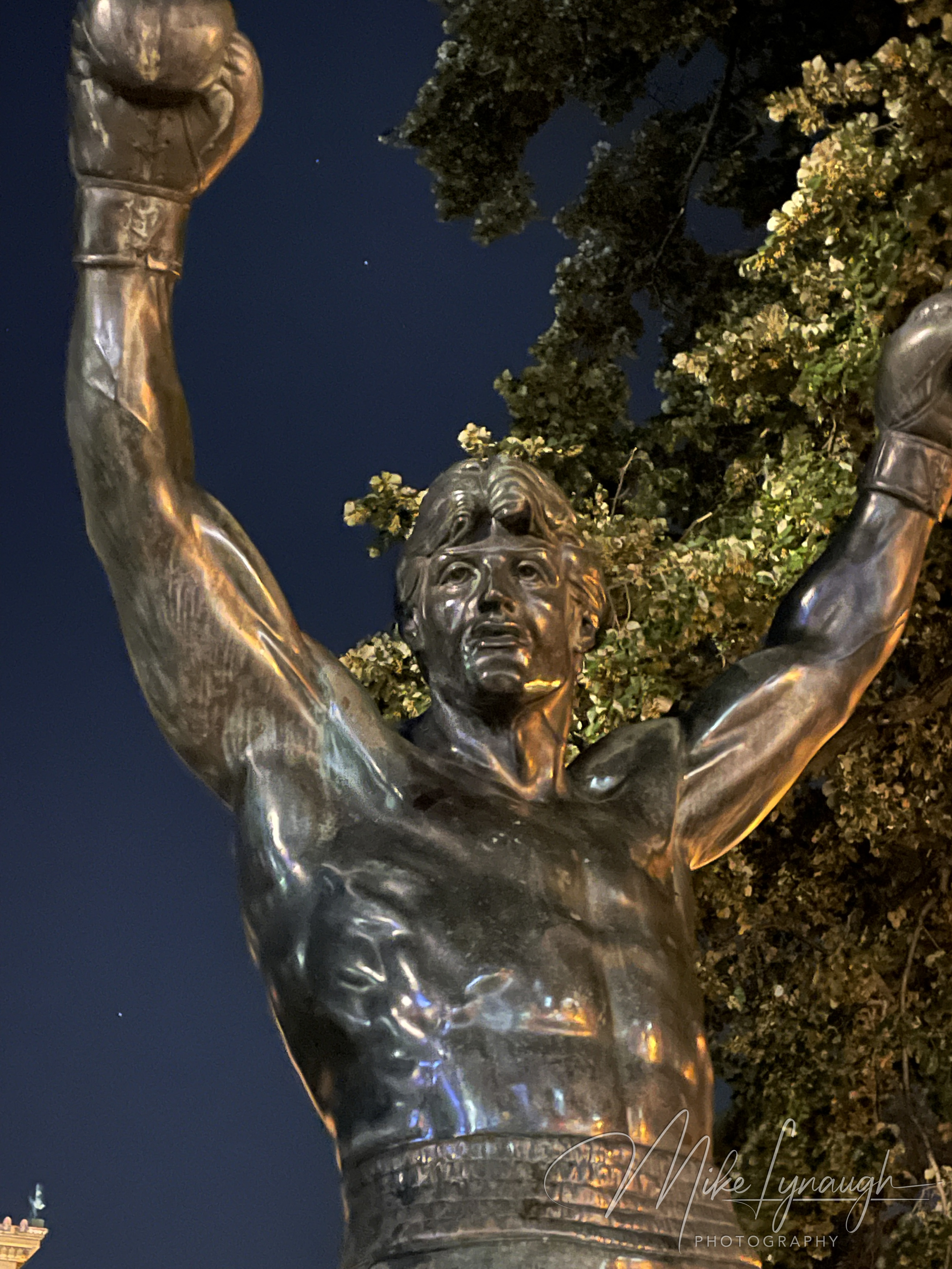 The original Rocky Statue that was featured in the movie Rocky III stands proudly at night at the base of the iconic Rocky Steps.