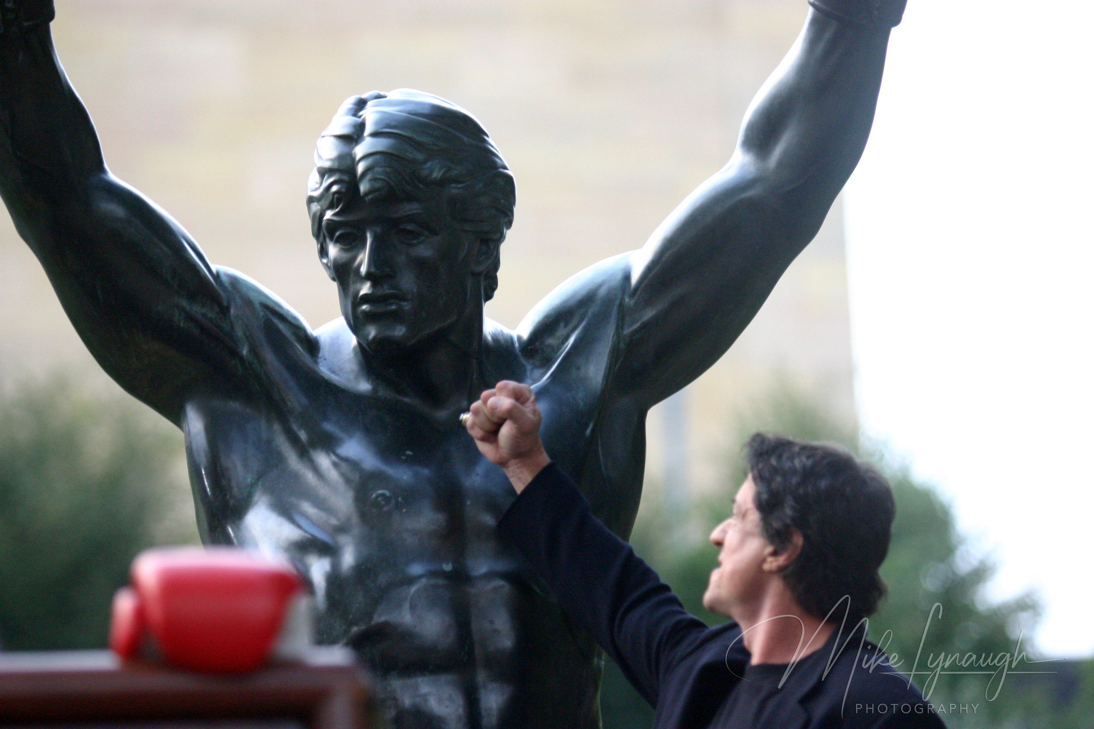 Sylvester Stallone enjoys the moment with the Rocky Statue following his speech at the rededication of the statue at the base of the Rocky Steps at the Philadelphia Museum of Art.