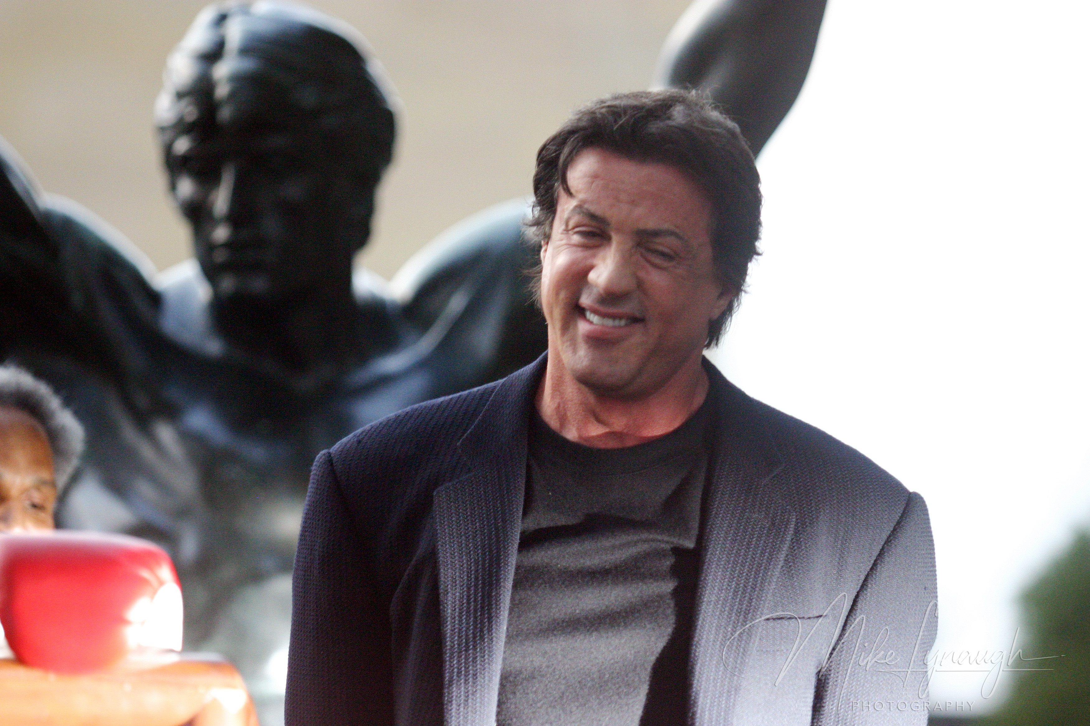 Sylvester Stallone enjoys the moment with the Rocky Statue following his speech at the rededication of the statue at the base of the Rocky Steps at the Philadelphia Museum of Art.