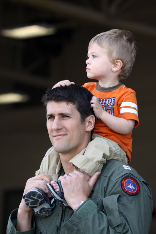Family members of VFA-81 aviators wait in anticipation as they return home to NAS Oceana from a 3 month deployment aboard the aircraft carrier USS Carl Vinson.  � Mike Lynaugh
