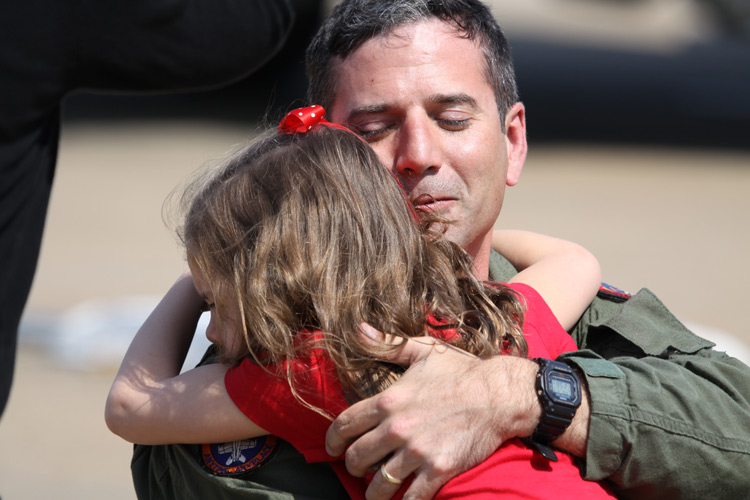 Lieutenant Commander Chad "Petey" Schumacher is welcomed home by his daughter after returning to NAS Oceana from a 3 month deployment aboard the aircraft carrier USS Carl Vinson.  � Mike Lynaugh