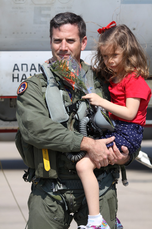 Lieutenant Commander Chad "Petey" Schumacher is welcomed home by his daughter after returning to NAS Oceana from a 3 month deployment aboard the aircraft carrier USS Carl Vinson.  � Mike Lynaugh