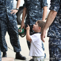 Family members and friends of the Aviators of VFA-83 "Rampagers" await their loved one's return home to Naval Air Station Oceana following a 6 month deployment in the Gulf on the USS Eisenhower on July 27, 2010.  � Mike Lynaugh