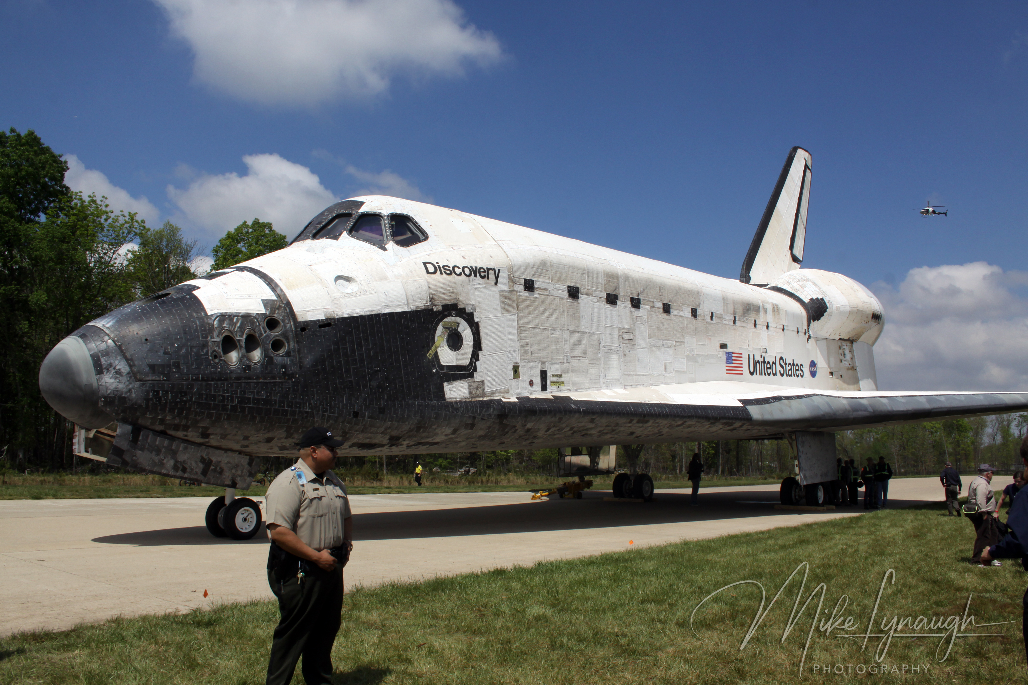 A wide-angle landscape photograph capturing Space Shuttle Discovery (OV-103) parked outdoors at the Steven F.
