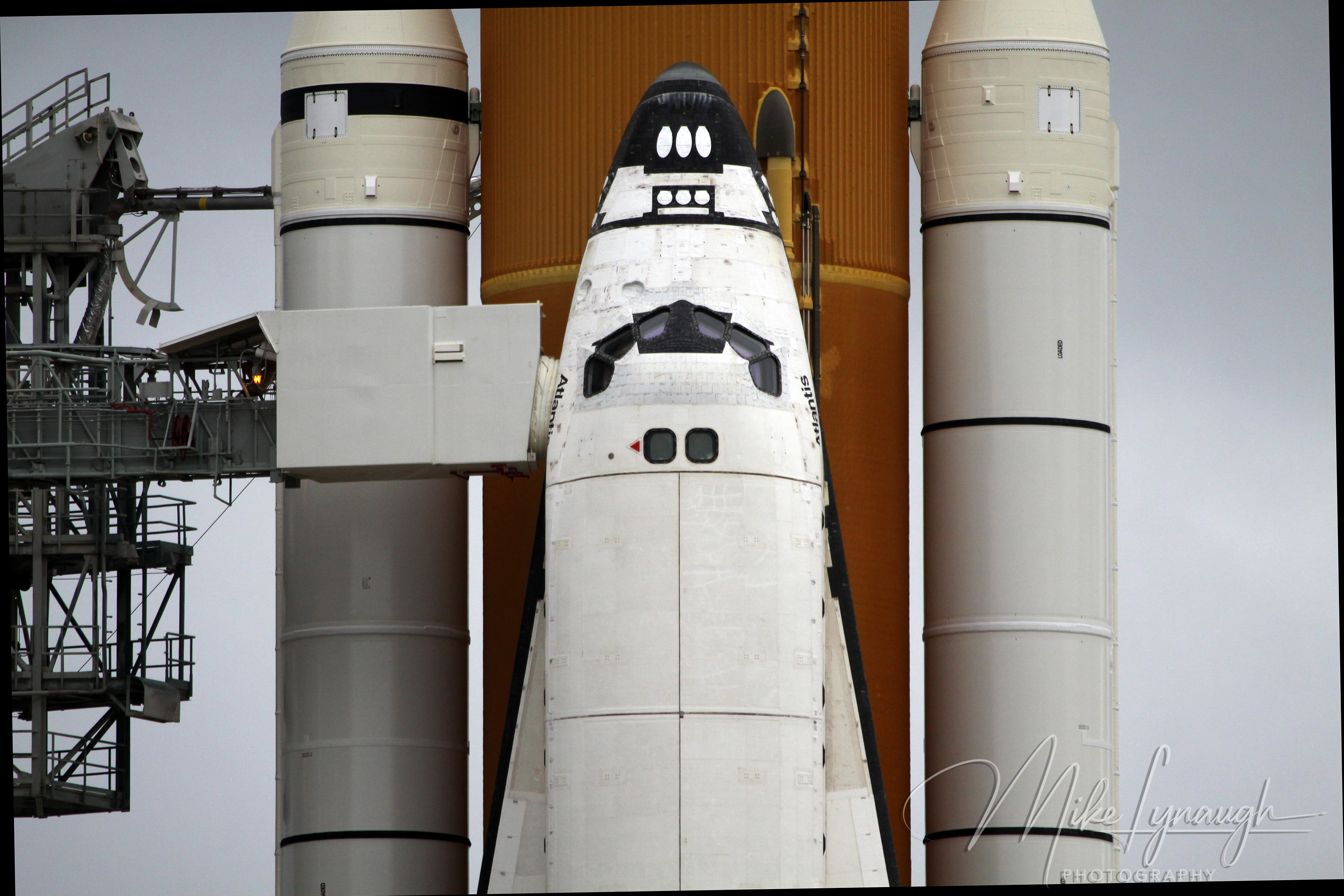 A tight telephoto detail shot of the nose cone and flight deck windows of Space Shuttle Atlantis (OV-104) on Launch Pad 39A at NASA’s Kennedy Space Center on July 7, 2011.